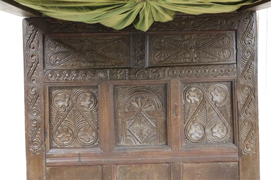 A 17th century carved oak tester bed, W.4ft 6in. H.6ft 1in. L.7ft 2in.